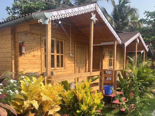 Happy Shack Garden Cottage side view of wooden cottage accommodation, surrounded by beautiful plants